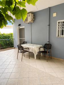 a patio with a table and chairs on a patio at Sunset Studios in Borsh