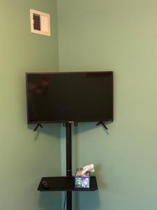 a flat screen tv on a stand on a wall at Spacious cozy in Jacksonville