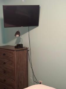 a flat screen tv sitting on top of a dresser at Spacious cozy in Jacksonville
