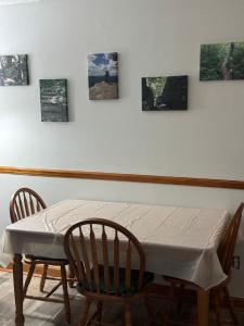 a dining room table with two chairs and pictures on the wall at Spacious cozy in Jacksonville