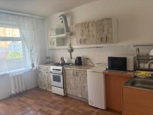 a kitchen with a sink and a stove top oven at Marsel Odesa in Odesa