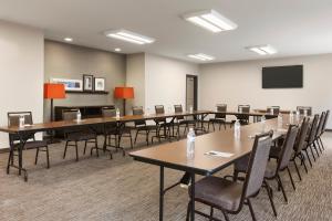 a conference room with tables and chairs and a screen at Country Inn & Suites by Radisson, Smithfield-Selma, NC in Smithfield +37 photos