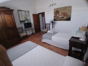 a bedroom with a bed and a table and a tv at Casa Rural Forcén in Lumpiaque