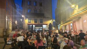 a crowd of people sitting at tables in a street at Loft Casco Viejo 4 in Ourense