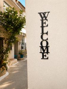 a sign on the side of a building with a street at Lichno Spirit in Vourliótai