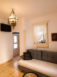 a living room with a couch and a window at Lichno Spirit in Vourliótai