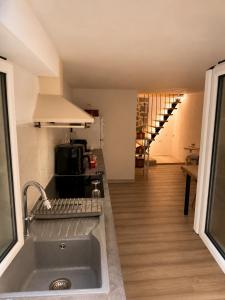 a kitchen with a sink and a counter top at Lichno Spirit in Vourliótai