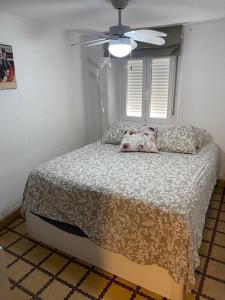 a bedroom with a bed and a ceiling fan at Los Marianos 