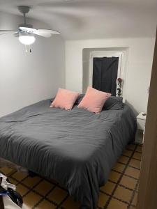 a bedroom with a large bed with two pink pillows at Los Marianos 