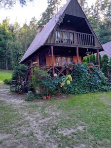 a large wooden house with a large porch at U Peterki in Woryty