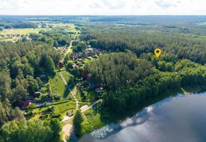 a yellow hot air balloon flying over a lake at U Peterki in Woryty +8 photos