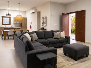 a living room with a couch and a table at Valley Farmhouse By Bait Zain in As Sīfah