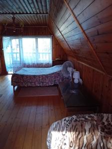 a bedroom with two beds in a wooden cabin at U Peterki in Woryty