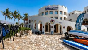 a building with surfboards parked in front of it at Valley Farmhouse By Bait Zain in As Sīfah