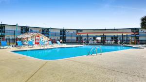 a large swimming pool with chairs and a building at CRYSTAL PALACE RESORT in Bolivar Peninsula