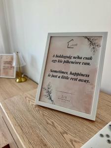 a picture frame sitting on top of a table at 2-6 Apartman Szeged in Szeged