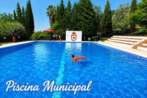 a child swimming in a swimming pool at Casa Paco & Carmela in Algodonales