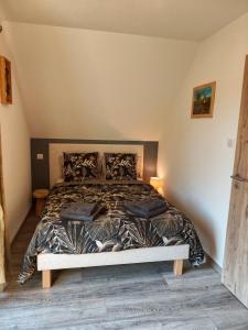 a bedroom with a large bed in a attic at Chez " Les Ligibell " in Wintzenheim