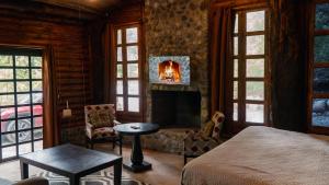 a bedroom with a bed and a fireplace in a room at Cabañas Cascada del Barro in Guajuquito +103 photos