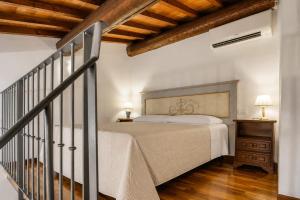 a bedroom with a large bed and a staircase at Accademia Residence in Prato