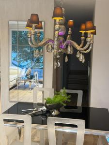 a dining room with a table and a chandelier at ENKLAWA IMPERIUM- DOM WAKACYJNY-APARTAMENTY NAD JEZIOREM- 20 km od TORUNIA-PLAŻA,JACUZZI  +30 photos