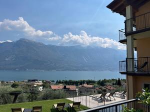 a balcony with chairs and a view of a mountain at Villa Imelda, panoramic apartments with Lake Garda views in Limone sul Garda