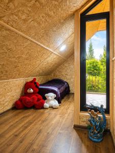 two stuffed animals sitting on the floor of a room at biker s home in Nabakhtevi +6 photos