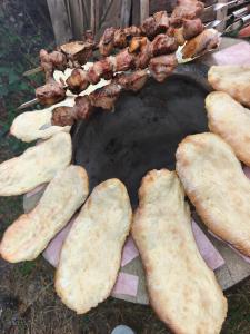 a group of bread and meat on a grill at biker s home in Nabakhtevi