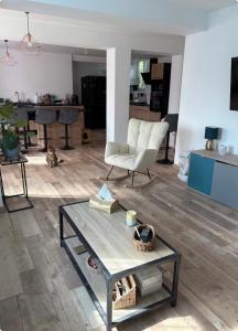 a living room with a table and a chair at Cécile Foissy in Pogny