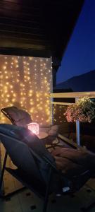 a patio with a table and a wall with lights at Apartman Romansa in Fojnica
