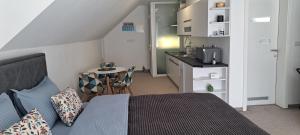 a bedroom with a bed and a small kitchen at Apartman Romansa in Fojnica