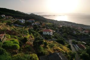 a small village on a hill with the ocean at Casa 52 in Machico