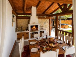 a dining room with a table and a fireplace at Chalet Velora in Oščadnica