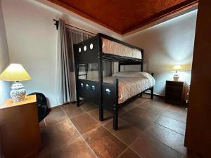 a bedroom with a black bed in a room at Casa Granada in Guanajuato