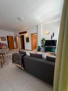 a living room with a couch and a table at Atlantic Romantic Caparica Flat in Costa da Caparica