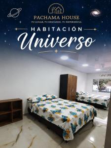 a bedroom with two beds and a sign for a astronomy museum at Pachamama House in Bucaramanga