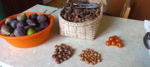 a table with a basket of nuts and a basket of tomatoes at Retro Kvirike in Kvirike