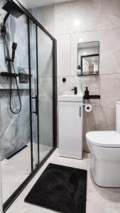 a bathroom with a shower and a toilet and a sink at The Studio Spot in Caerphilly +16 photos