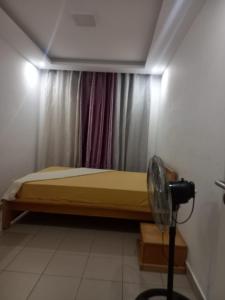 a bedroom with a bed with a window and a fan at Sunset Serenity Flat in Praia