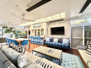 a living room with a couch and a table at Barbara's Byron Bay in Byron Bay