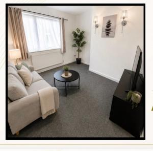 a living room with a couch and a table at 5, Casper Court in Nottingham
