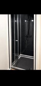 a shower with a glass door in a bathroom at 5, Casper Court in Nottingham