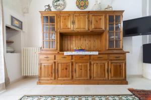 a large wooden cabinet in a living room at Casa Meravigliosa in Ostuni