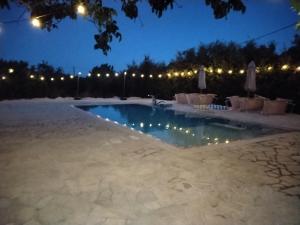 a swimming pool at night with lights at La Macchia in Botrugno