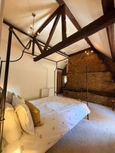 a bedroom with a canopy bed in a attic at Braunston Manor Cottage in Braunston