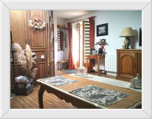 a living room with a coffee table in a room at Chambre d'hôtes de Marie in Chémery