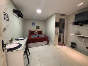 a small bedroom with a bed and a sink at Flats 1778 N01 Orla de Petrolina in Petrolina