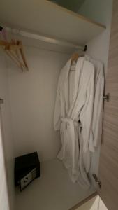 a bathroom with white towels hanging on a door at Archontiko Chios Traditional Mansion in Thymianá +16 photos