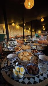 a table with many plates of food on it at Auberge de Chez Momo in Asilah