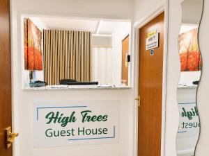 a sign that reads high trees guest house in a hallway at High Trees Guest House Gatwick in Horley